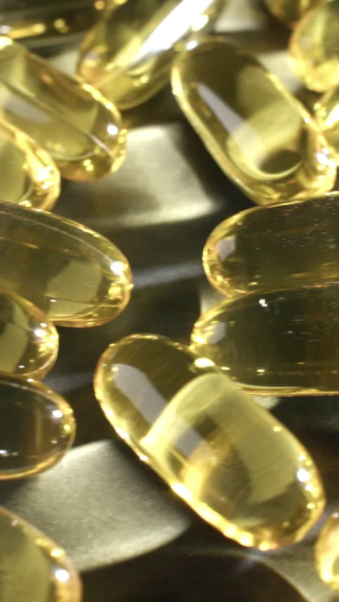 Vertical Omega 3 Capsules Macro Tracking Shot Video stock 332370321