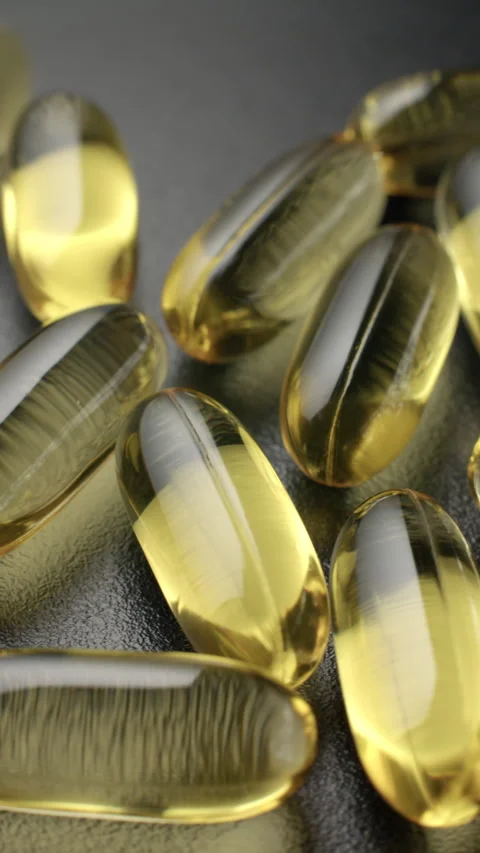 Vertical Omega 3 Softgels Rotating Macro Video stock 332378039