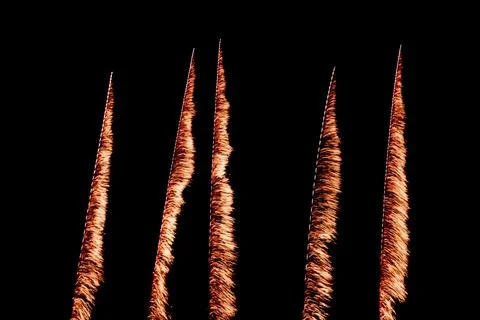 Vertical Orange Firework Trails on Black Night Sky Stock Photos