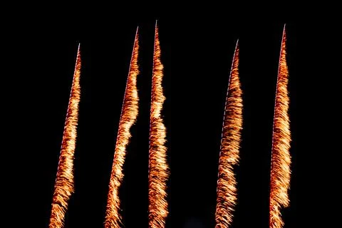 Vertical Orange Firework Trails on Black Night Sky Stock Photos