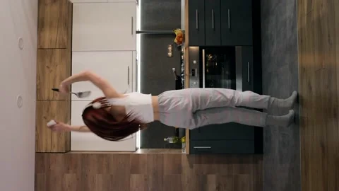 Vertical orientation for stories of Pretty young woman in headphones dancing in Stock Footage 146409241