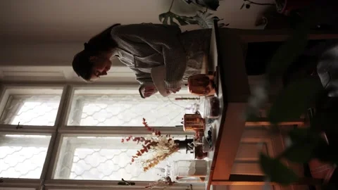 Vertical orientation for stories of young beautiful woman in apron in kitchen Stock Footage 143996769