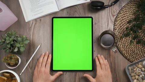 Vertical orientation tab with green screen. Hand tap on center then wait. Video stock 129391920