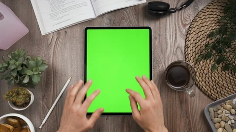 Vertical orientation tab with green screen. Top view. Hands typing message. Stock Footage 129395021