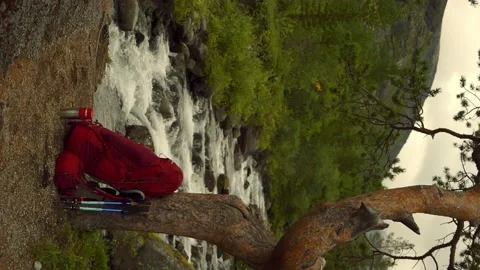 Vertical orientation. Tourist backpack in front of the river. Travel and tourism Stock Footage 165181175