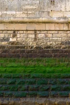 A vertical oriented photograph of a heavy blockwork harbour wall Stock Photos