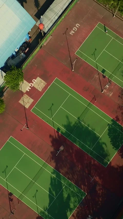 Vertical overhead drone view of outdoor tennis court complex Stock Footage 342589677