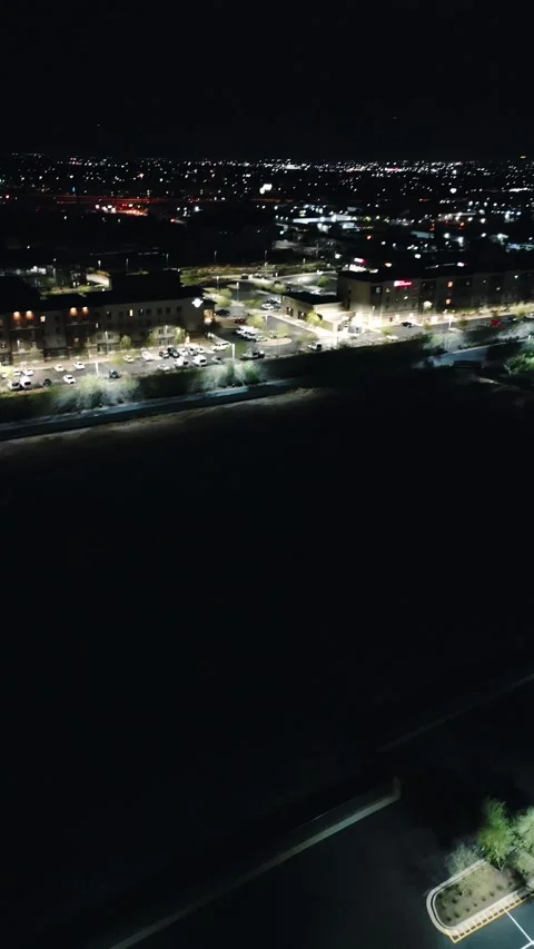 VERTICAL OVERHEAD PANNING NIGHT PARKING LOT DRONE SHOT Stock Footage 248578505