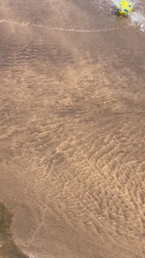 Vertical Overhead Shot of Clear Water Flowing Over Rippled Sand Stock Footage 340775137