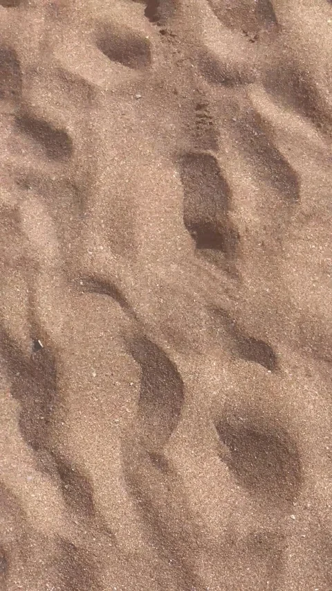 Vertical Overhead View of Textured Rippled Sand on Shoreline Stock Footage 340775035