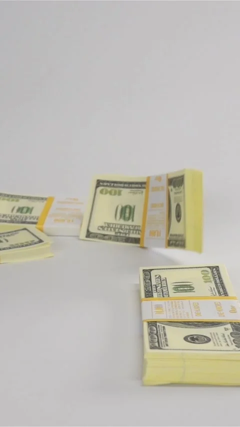 Vertical of Packs of dollars falling on white surface Stock Footage 305481311