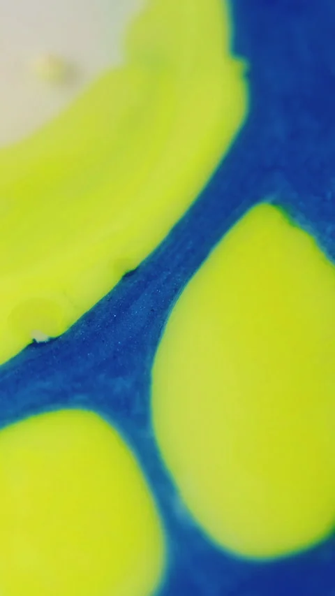 Vertical paint blob ink blend yellow blue dye mix Stock Footage 288793855