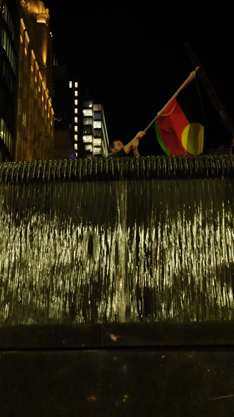 Vertical Palestine Flag waved above fountain at Sydney protest 6K Stock Footage 310480911