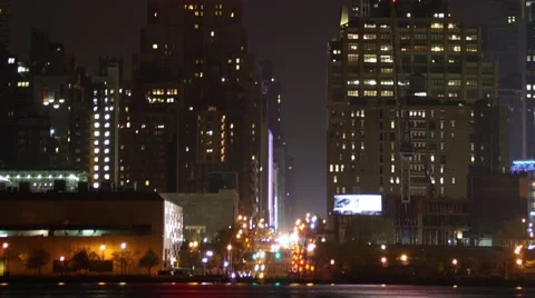 Vertical Pan of the Empire State Building and Moon behind clouds Video stock 62565850
