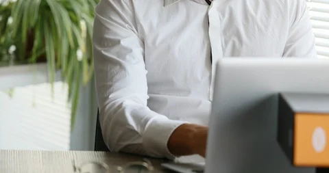 Vertical pan of a man writing, then horizontal looking out Stock Footage 91471900