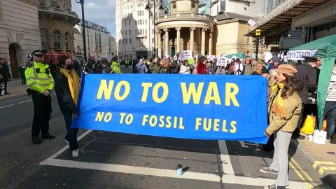 Vertical pan no to war banner front of march London march to support ukraine Stock Footage 171516631