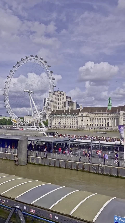 Vertical pan right of passenger ferry departs from Westminster pier in London Stock Footage 314974226