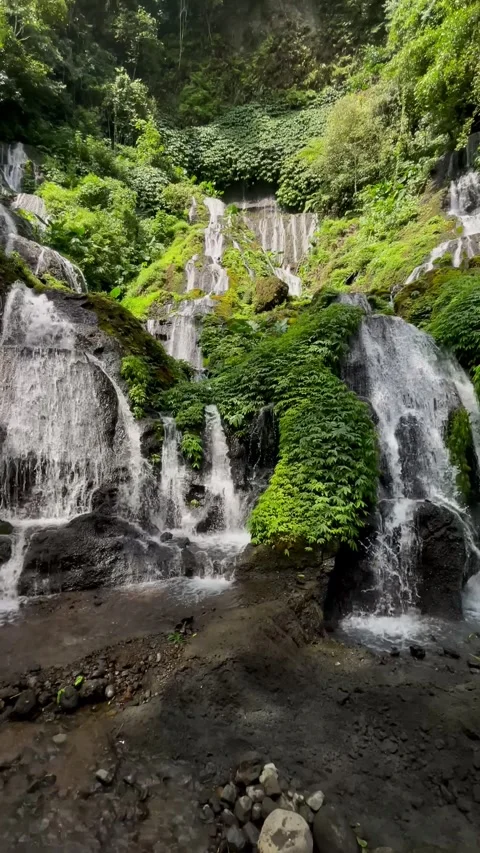 Vertical Pan Shot of Multi Tiered Cascade Waterfall in Bali Stock Footage 340562220