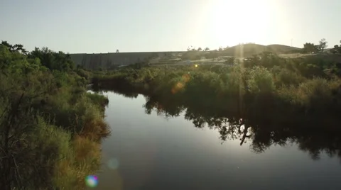 Vertical pan shot of river leading up to a dam in Fresno California Video stock 64796520