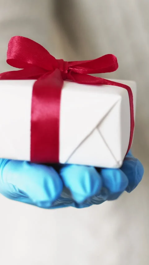 Vertical pandemic gift virus present hand hold box Stock Footage 255546947