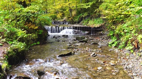 Vertical panning footage of streaming mountain river and waterfalls Stock Footage 119961846