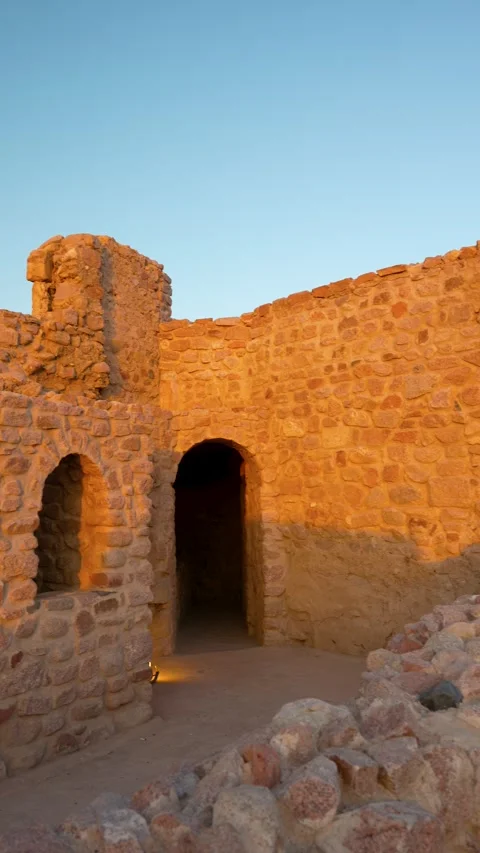 Vertical panning shot of Aqaba Castle ancient stone desert ruin with arched Stock Footage 332485037