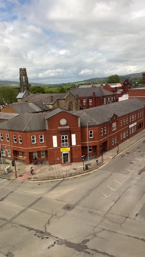 Vertical. Panning shot of part of Bury town centre through window Stock Footage 335929923