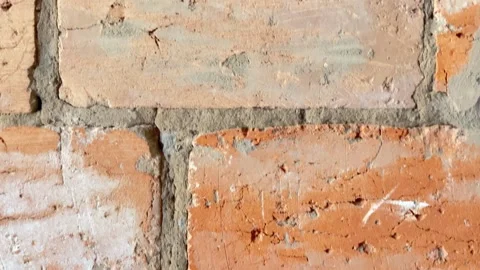 Vertical panning shot of a textured red brick wall Stock Footage 336448530