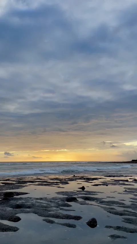 Vertical Panning Sunset Beach with Rocky Tidal Pools in Bali Stock Footage 337270215