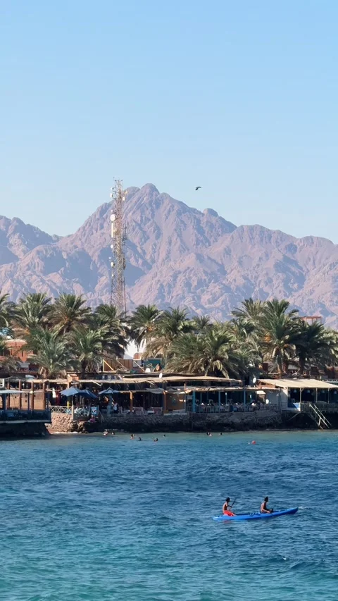 Vertical panorama of Dahab waterfront with seaside restaurants and mountains Stock Footage 341452175