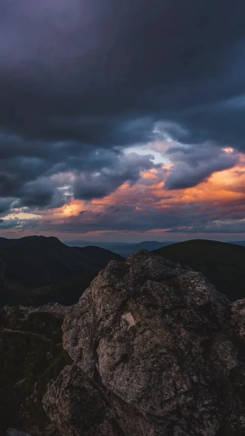 Vertical Panorama of fast clouds moving over rocky mountains nature at sunset Stock Footage 295852230