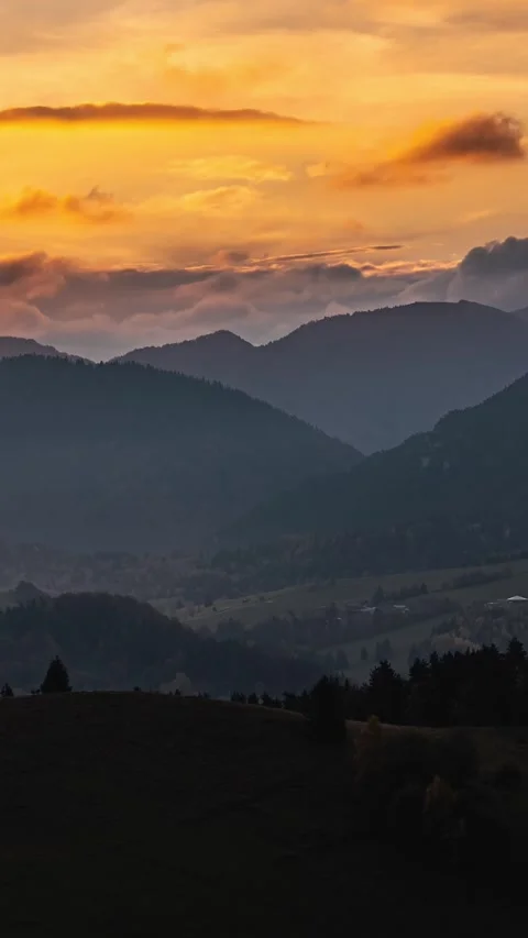 Vertical panorama of golden clouds sunset sky over autumn mountains time lapse Stock Footage 265797779
