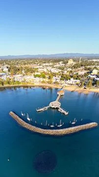 Vertical panorama of Redcliffe Pier, bait ball in foreground Stock Photos