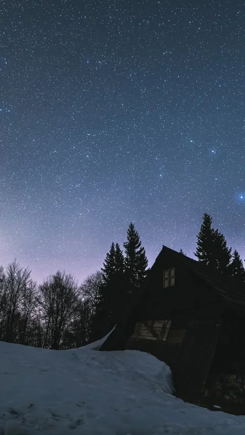 Vertical panorama of starry sky over forest and cabin in winter night, Time Stock Footage 307705469