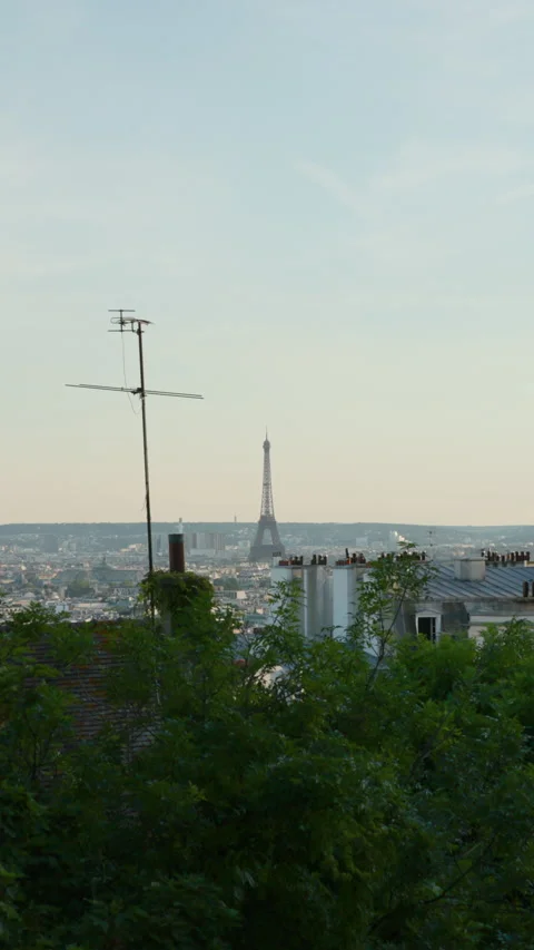 Vertical panoramic view across the rooftops of Paris framing the iconic Eiffel T Stock Footage 337414083