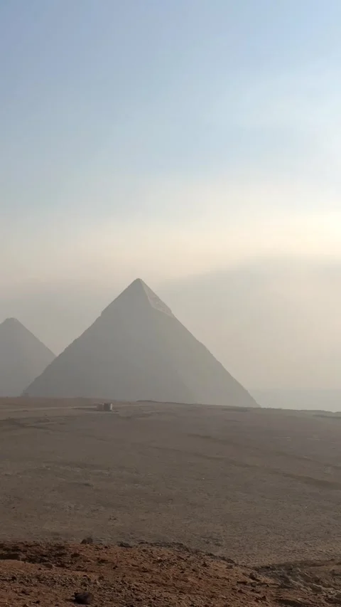 Vertical panoramic view of the Giza Pyramids silhouettes in the distance at Stock Footage 341838301