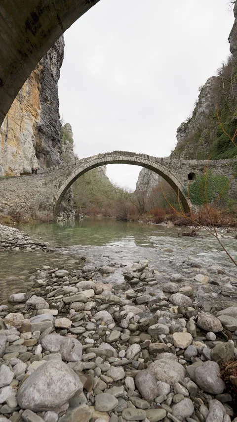 Vertical panoramic view of Kokkoris Bridge spanning Voidomatis river gorge Stock Footage 334591284