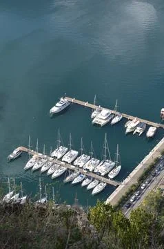 Vertical Panoramic View of Kotor Bay with Red Roofs and Mountains Stock Photos