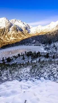 Vertical panoramic view of winter mountains, lake and cottage, Slovakia Stock Photos