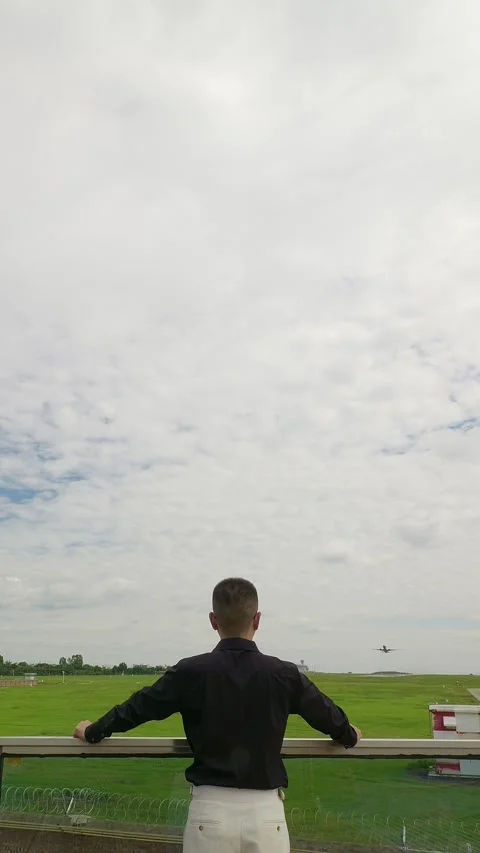 Vertical: A passenger plane flies over a Chinese businessman. Stock Footage 346502779
