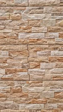 Vertical pattern of rectangular beige and brown stone tiles Stock Photos