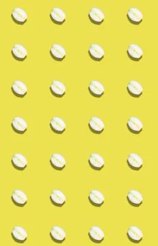 Vertical pattern of sliced onions on a yellow background. Vegetable template. Stock Photos