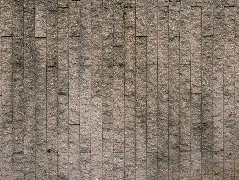 Vertical pattern of textured stone tile wall, modern beige granite or sands.. Stock Photos