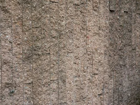 Vertical pattern of textured stone tile wall, modern beige granite or sands.. Stock Photos