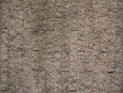 Vertical pattern of textured stone tile wall, modern beige granite or sands.. Stock Photos