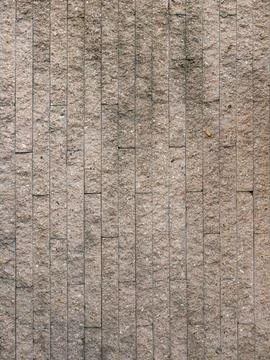Vertical pattern of textured stone tile wall, modern beige granite or sands.. Stock Photos