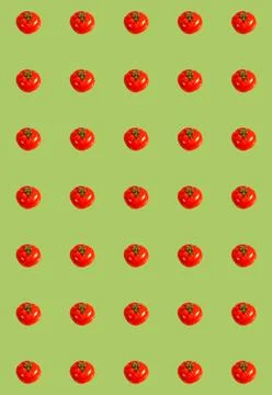 Vertical pattern with whole red tomatoes on a green background. Vegetable bac Stock Photos