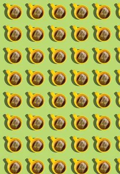Vertical pattern with yellow cups and tea bags on a green background. A tea b Stock Photos