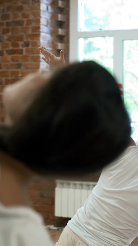 Vertical of People lean to side spreading hands at yoga class in studio Stock Footage 275620560