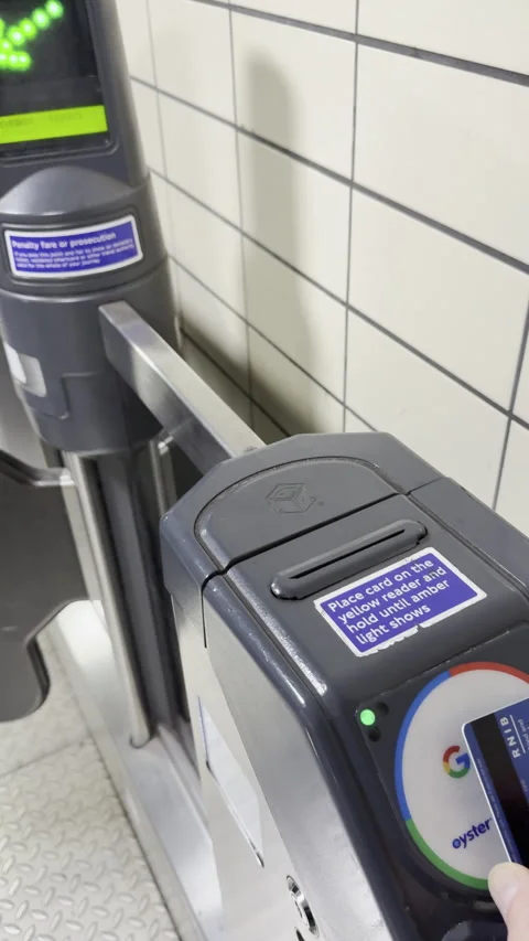 Vertical - People passing through an entry barrier, for access to a tube train. Stock Footage 293445435